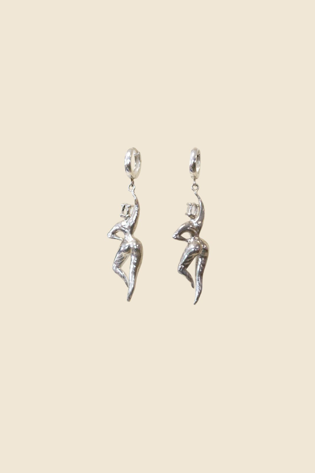 Ce Fain! Aethera sterling silver huggie earrings featuring a sculpted goddess figure with a pale blue stone accent.