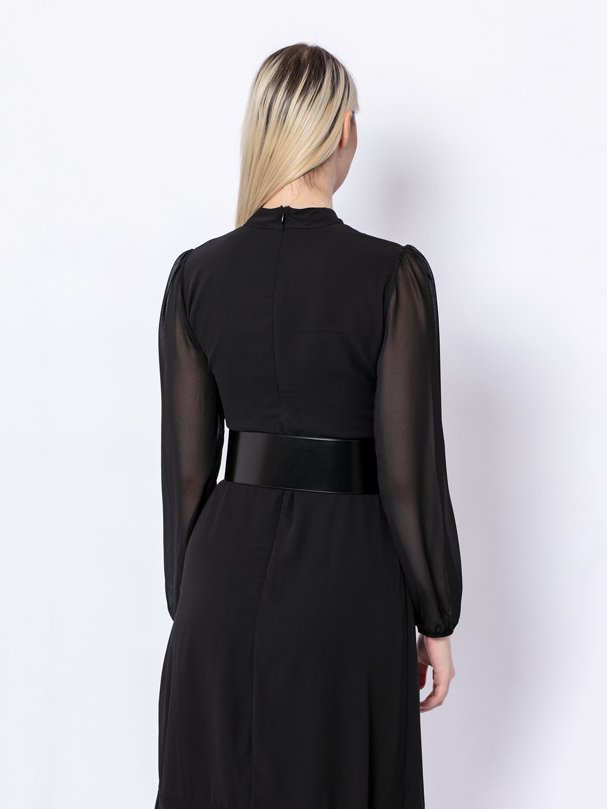 Back view of wide corset belt worn by model over black dress.