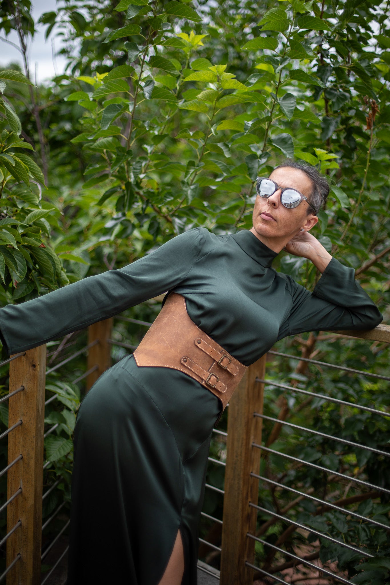Tan leather corset waist belt with double buckle closure, worn over green dress