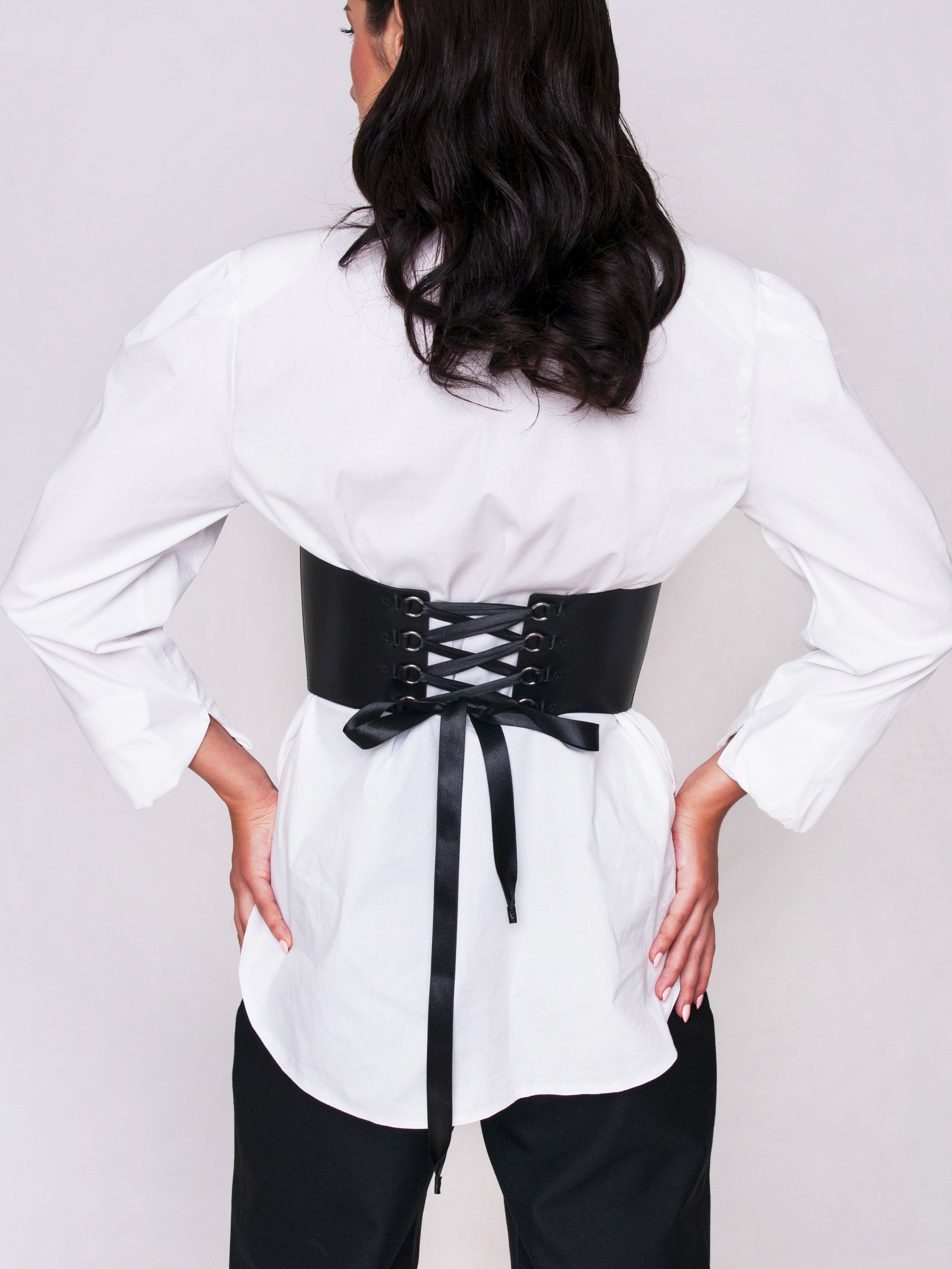 Back view of the Black Corset Top worn by woman.