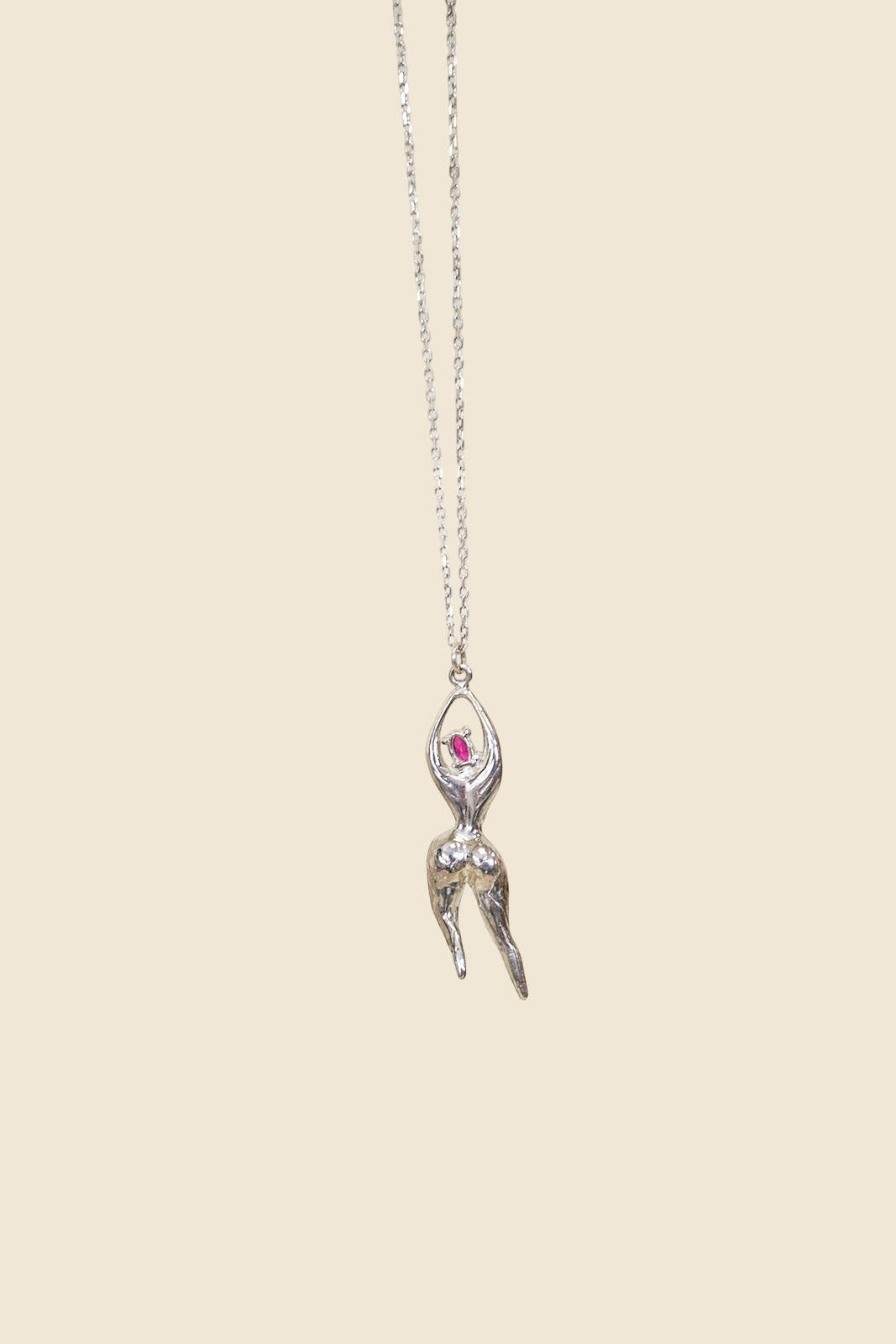 Ce Fain! Vesta sterling silver pendant featuring a stylized goddess figurine with a vibrant red stone on a long chain.
