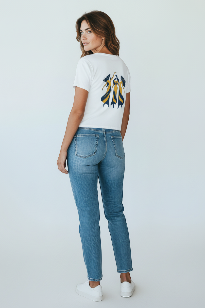 Ce Fain! white crop top with scoop neck and raw hem, featuring a graphic of three women in yellow and navy striped dresses.