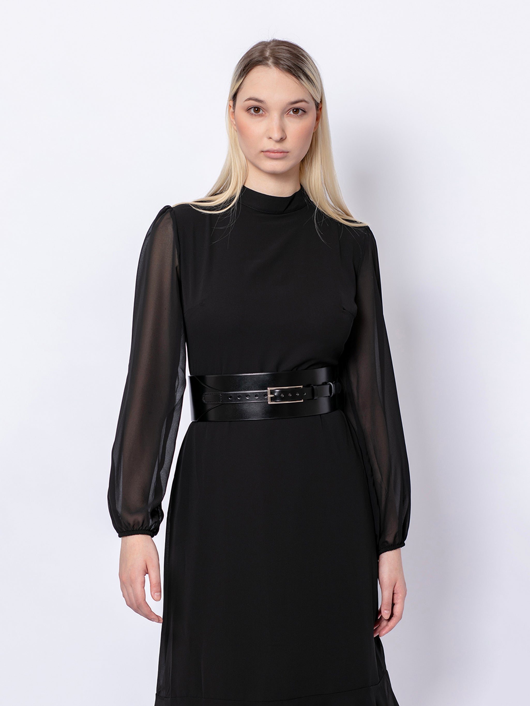 Front view of wide corset belt worn by model over black dress.